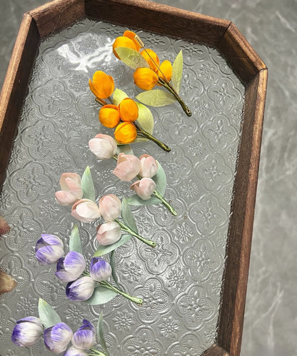 Handmade Ronghua tulip brooches in orange, pink, and lavender-purple mulberry silk velvet flowers on glass tray
